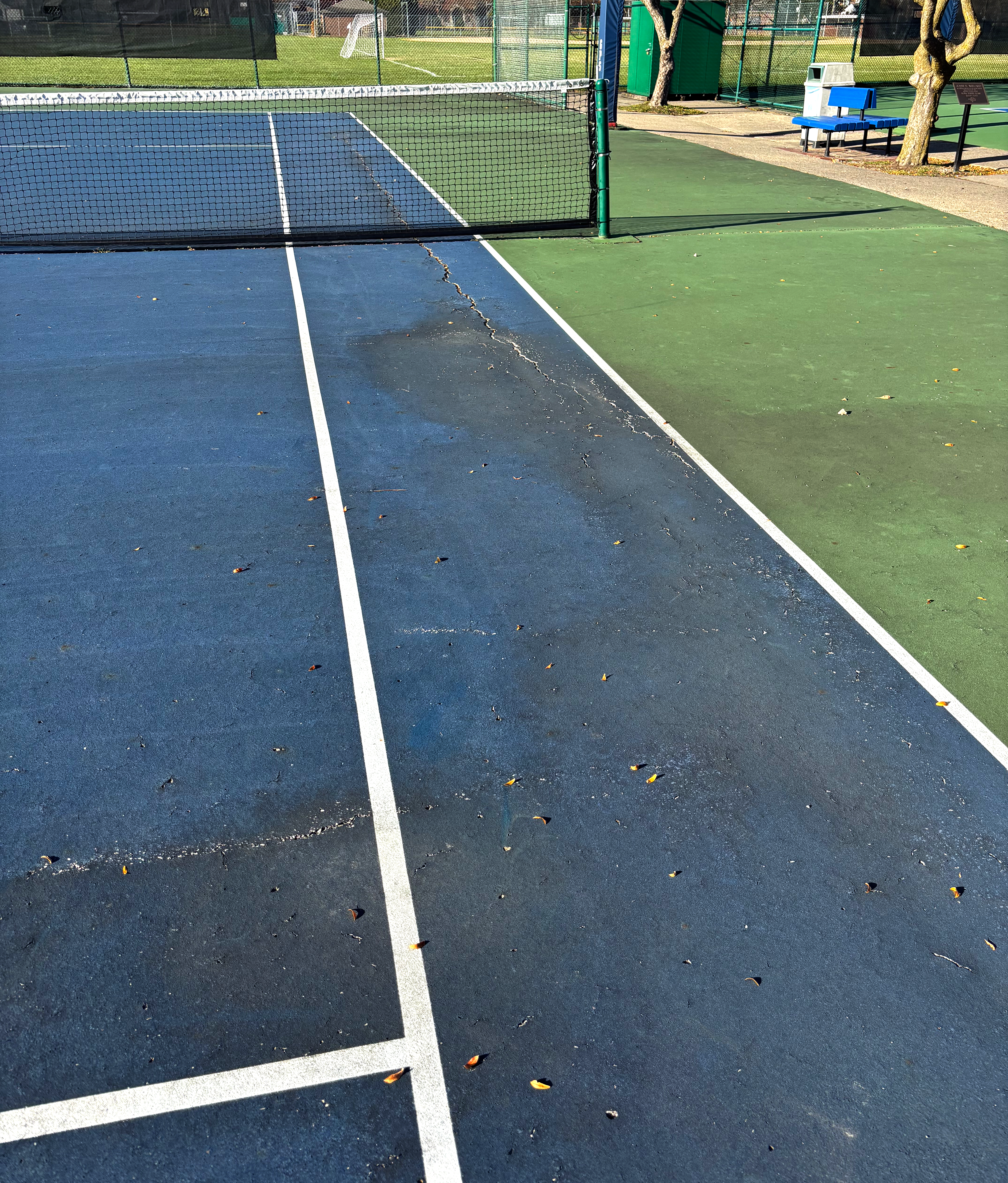 Cracked tennis courts at Elworthy Field